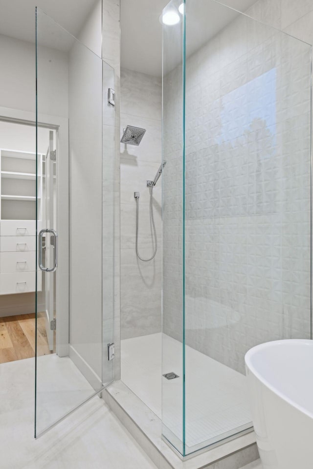 bathroom featuring independent shower and bath and wood-type flooring