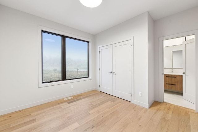 unfurnished bedroom with light wood-type flooring