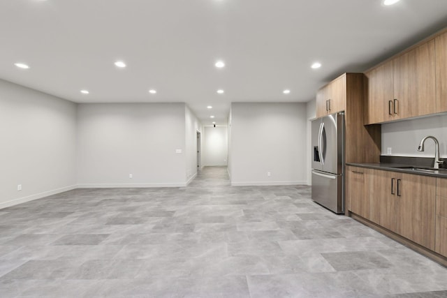 kitchen featuring sink and stainless steel fridge with ice dispenser