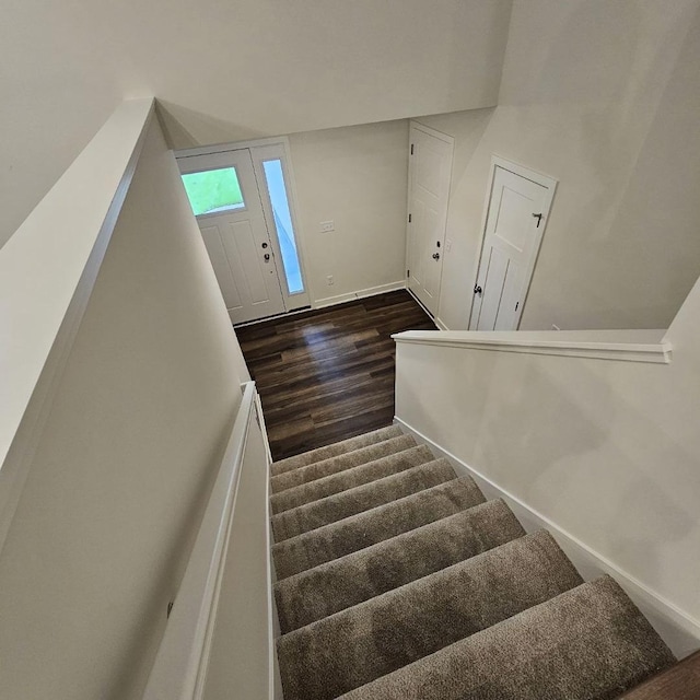 stairway with hardwood / wood-style floors