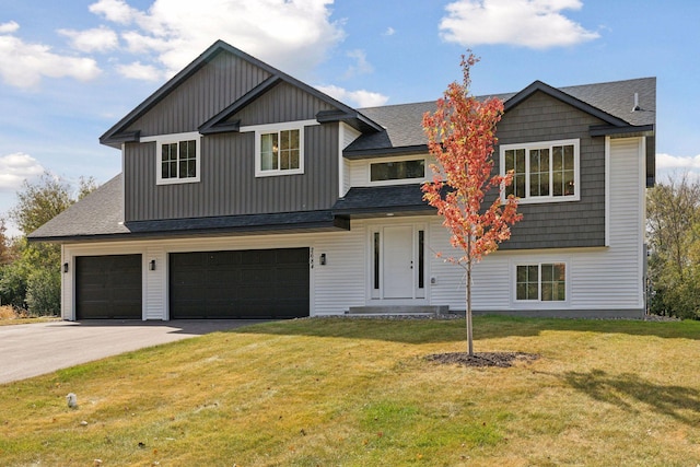 view of front of home featuring a garage and a front lawn