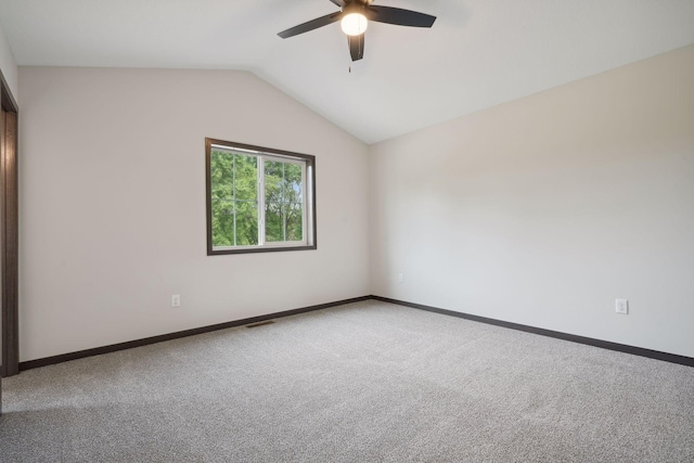 carpeted empty room featuring ceiling fan and vaulted ceiling