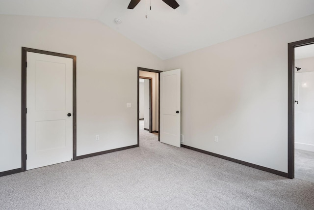 unfurnished bedroom featuring ceiling fan, light colored carpet, and vaulted ceiling