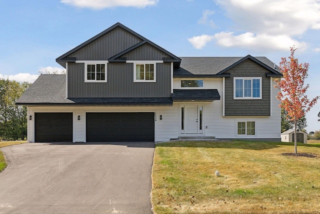 view of front of property with a front yard and a garage