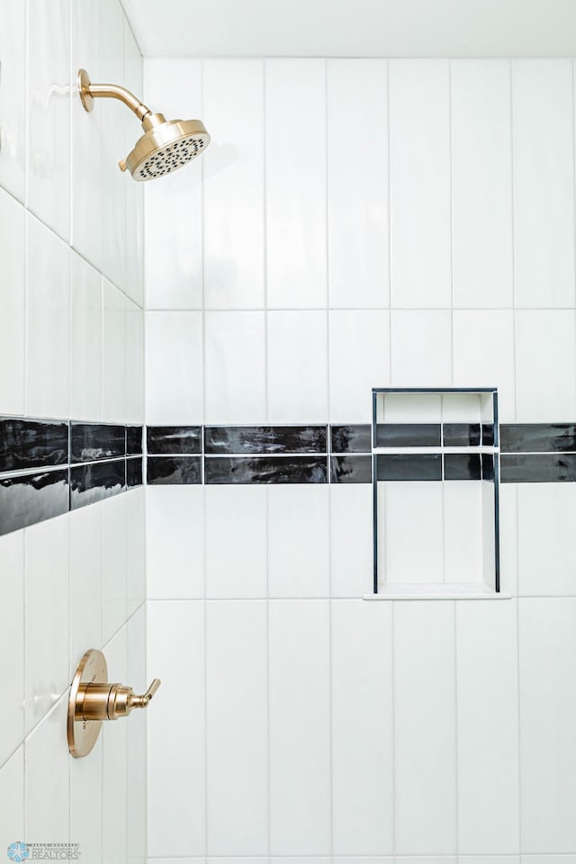 interior details featuring a tile shower