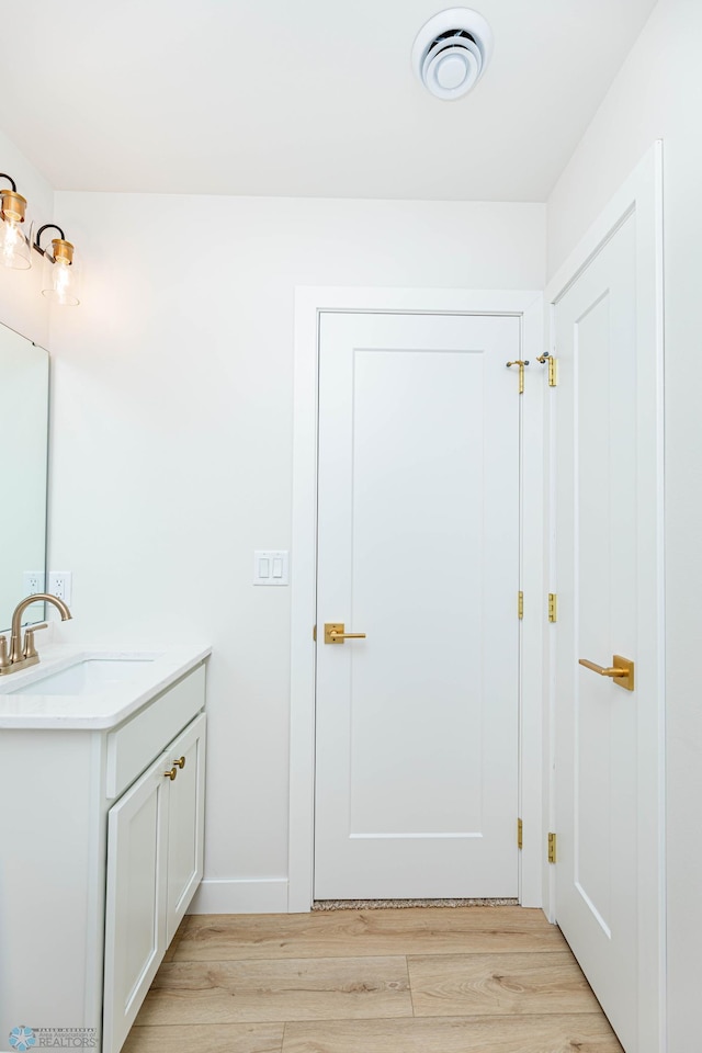 bathroom featuring vanity and hardwood / wood-style flooring