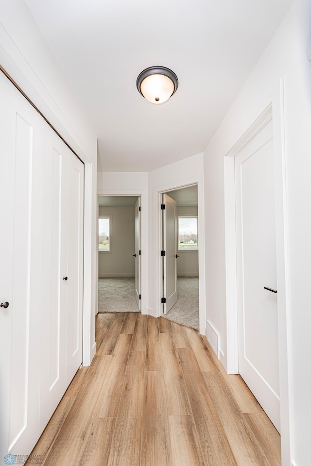 corridor featuring light hardwood / wood-style floors