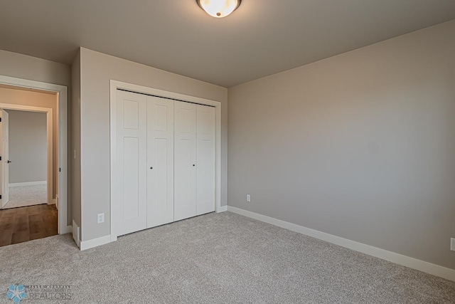 unfurnished bedroom featuring carpet flooring and a closet