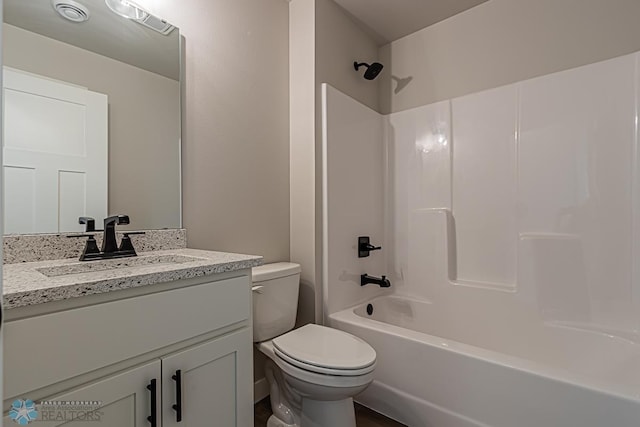 full bathroom featuring shower / washtub combination, vanity, and toilet