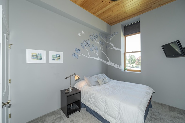 bedroom featuring wood ceiling and carpet floors