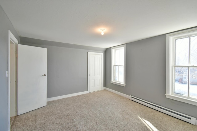 303 Alexandria St NW, Evansville, MN 56326 - carpeted spare room with a baseboard radiator