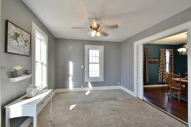 303 Alexandria St NW, Evansville, MN 56326 - entryway featuring carpet flooring and ceiling fan with notable chandelier