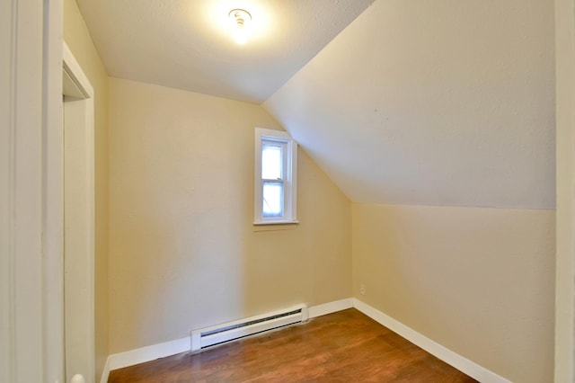 303 Alexandria St NW, Evansville, MN 56326 - bonus room featuring a textured ceiling, lofted ceiling, wood-type flooring, and baseboard heating