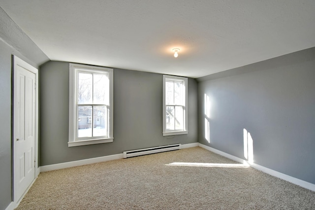 303 Alexandria St NW, Evansville, MN 56326 - carpeted spare room featuring a textured ceiling, a baseboard radiator, and vaulted ceiling