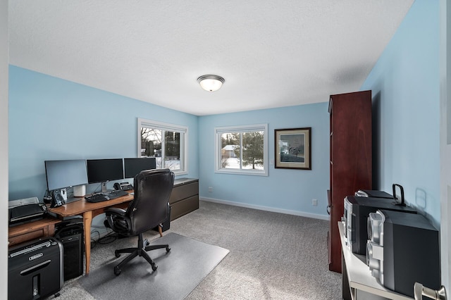 carpeted office space with a textured ceiling