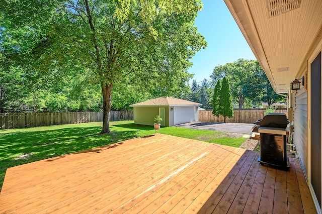 wooden terrace featuring an outbuilding, area for grilling, a garage, and a yard