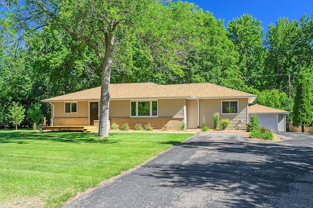 ranch-style home with a garage and a front yard