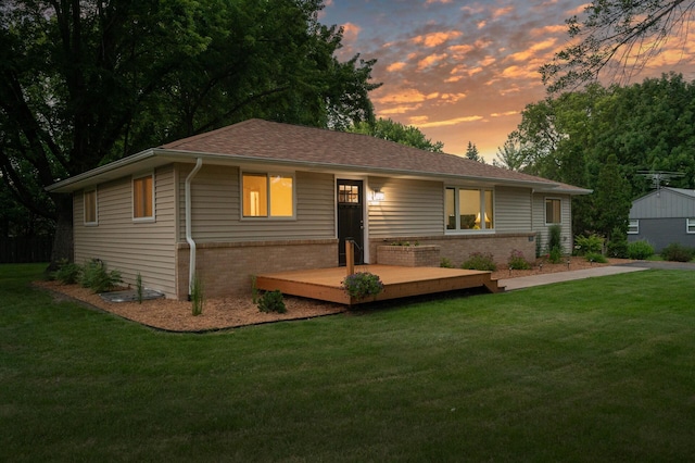 ranch-style house with a yard and a deck