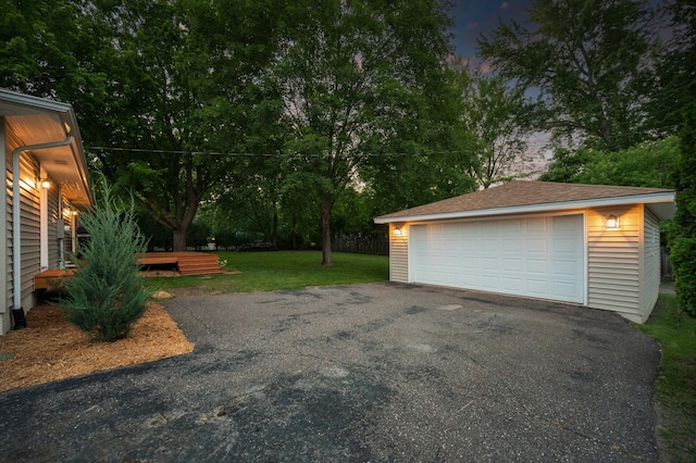 garage at dusk with a yard