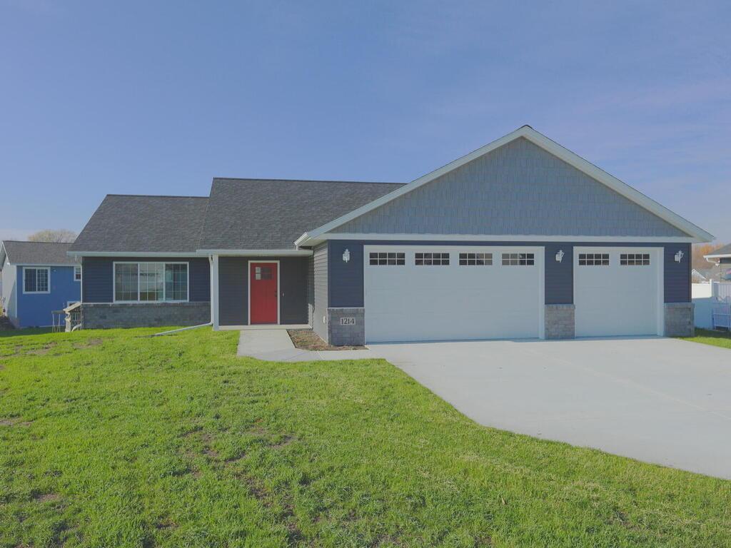 view of front facade with a front yard and a garage