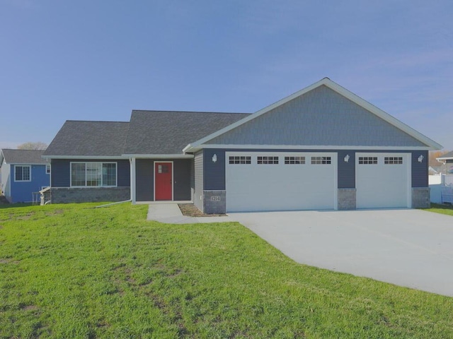 view of front facade with a front yard and a garage