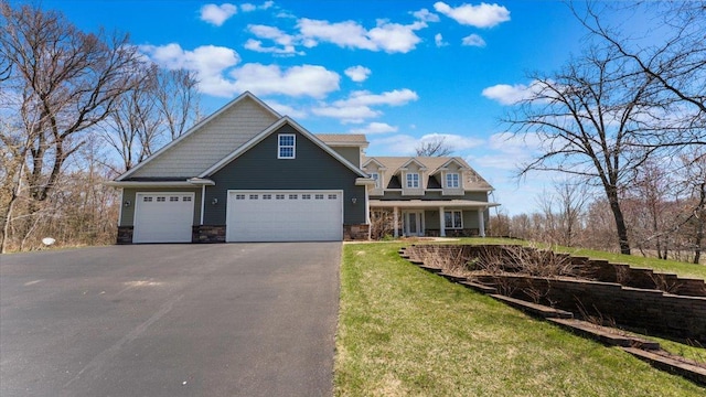 24455 Crocus St NW, Saint Francis, MN 55070 - craftsman inspired home with covered porch, driveway, a front yard, an attached garage, and stone siding