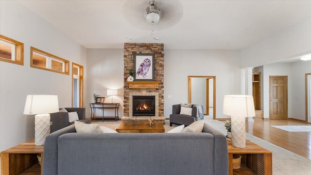 24455 Crocus St NW, Saint Francis, MN 55070 - living area featuring baseboards, a fireplace, a ceiling fan, and light wood finished floors