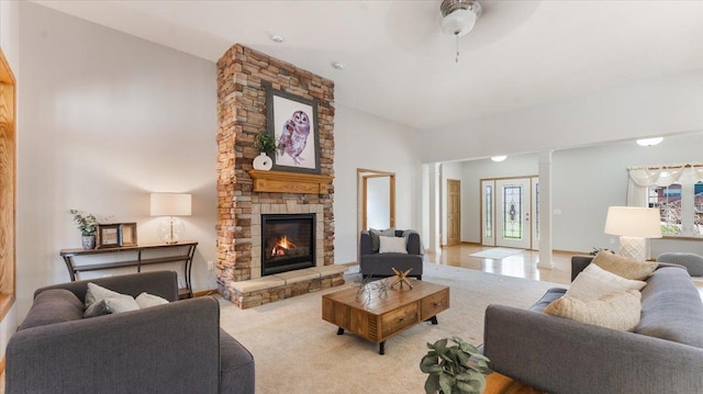 24455 Crocus St NW, Saint Francis, MN 55070 - living area with a ceiling fan, decorative columns, and a stone fireplace