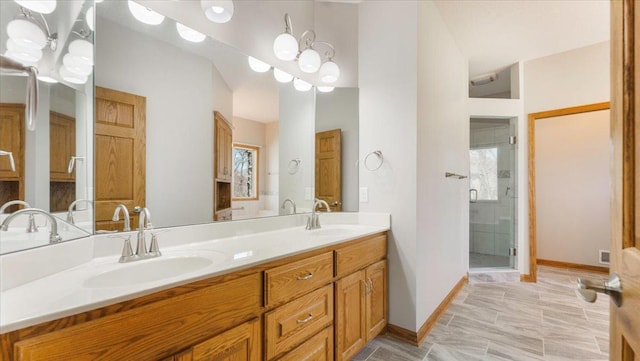 24455 Crocus St NW, Saint Francis, MN 55070 - bathroom featuring double vanity, a sink, baseboards, and a stall shower
