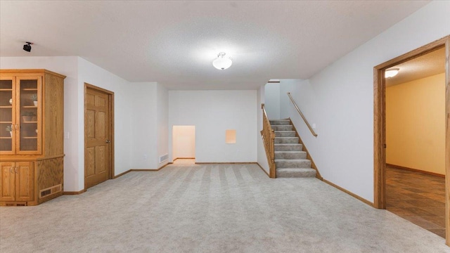 24455 Crocus St NW, Saint Francis, MN 55070 - finished below grade area with baseboards, light carpet, and stairway