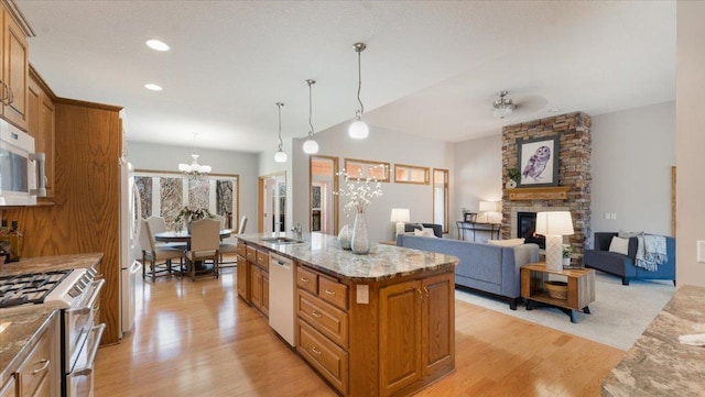 24455 Crocus St NW, Saint Francis, MN 55070 - kitchen featuring white appliances, brown cabinets, a chandelier, and light wood-style flooring