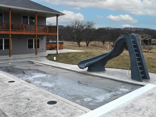 exterior space with a yard, a patio, and a hot tub