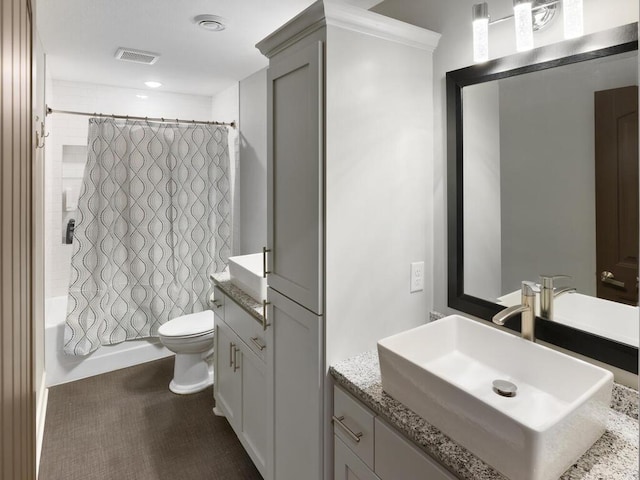 full bathroom with shower / bath combination with curtain, toilet, and vanity