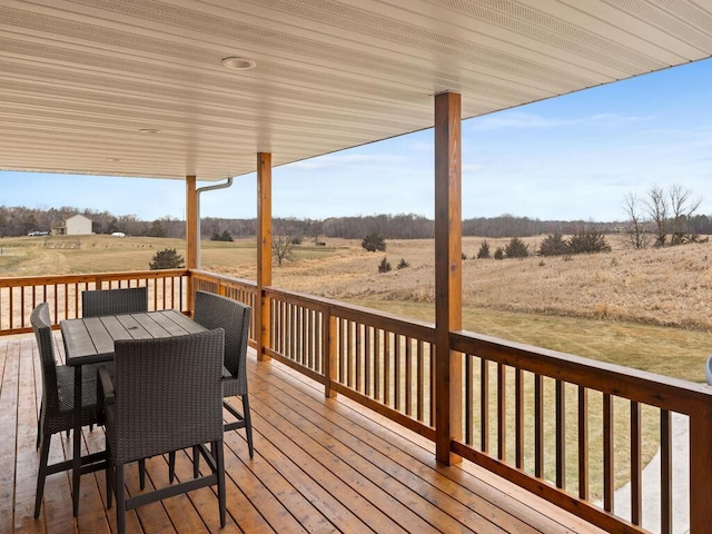 wooden deck with a rural view