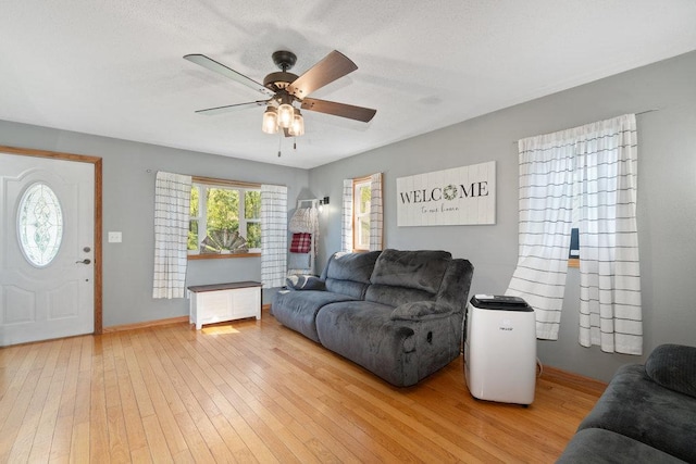 living room featuring ceiling fan and wood-type flooring