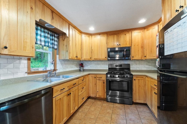 kitchen featuring light tile patterned floors, backsplash, stainless steel appliances, and sink