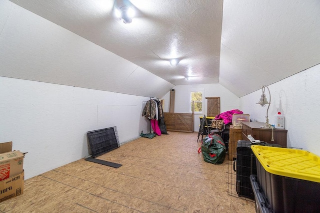 bonus room with a textured ceiling and vaulted ceiling