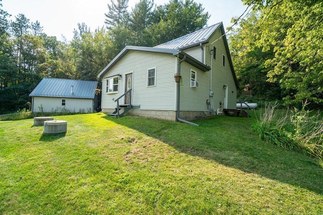 rear view of property with a lawn