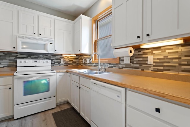 kitchen featuring white cabinets, white appliances, backsplash, and sink