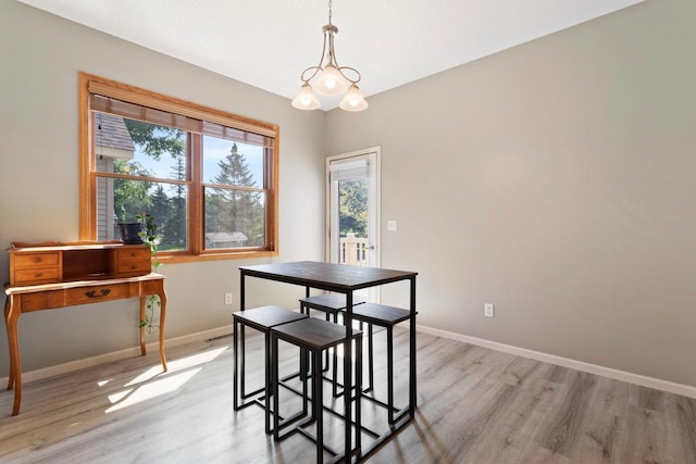 dining room featuring an inviting chandelier and light wood-type flooring