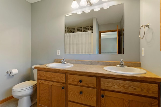 bathroom featuring vanity, toilet, and curtained shower