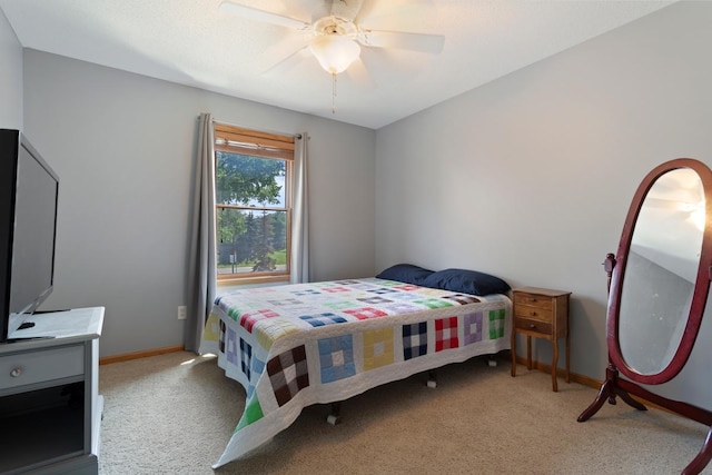 bedroom featuring ceiling fan and light carpet