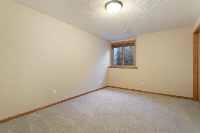 carpeted empty room with a textured ceiling