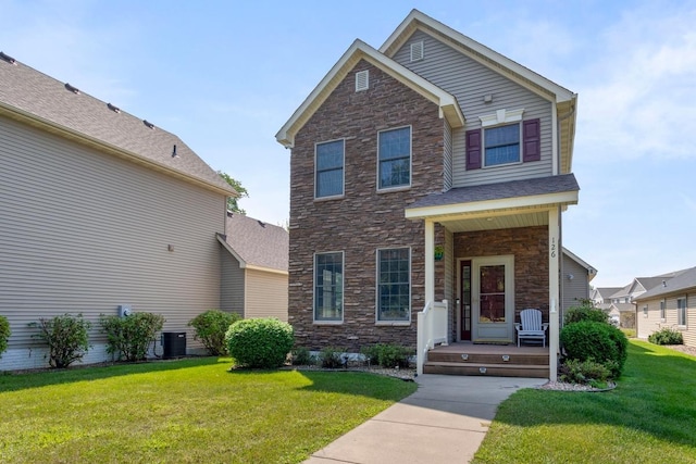 view of front of house with central AC and a front lawn