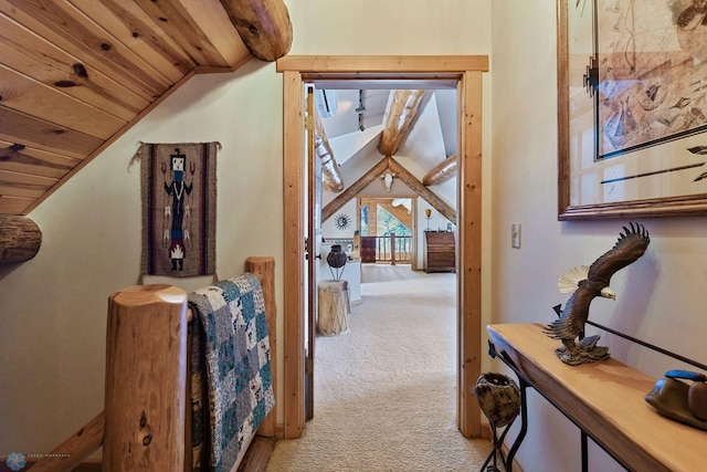 hall with wooden ceiling, light carpet, and vaulted ceiling