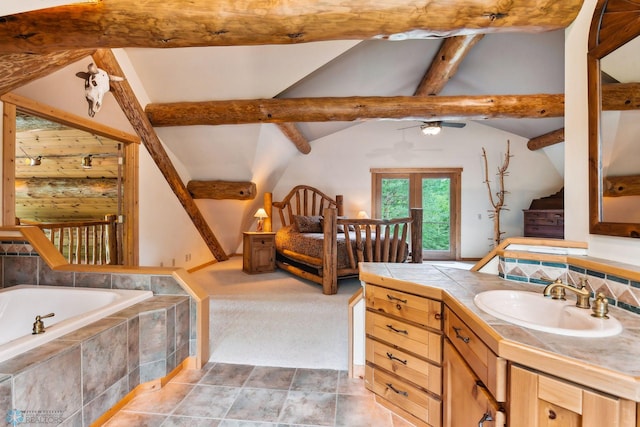 bathroom featuring tiled tub, vanity, and lofted ceiling with beams