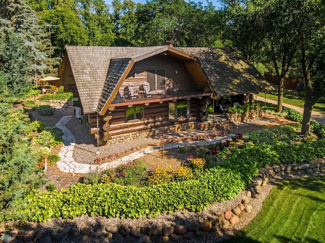 view of front of home featuring a balcony and log exterior