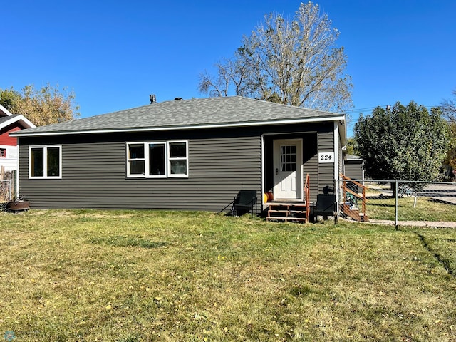 rear view of property with a yard