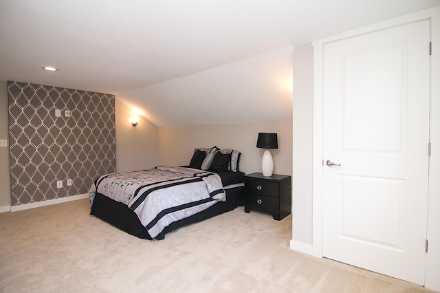 carpeted bedroom with vaulted ceiling