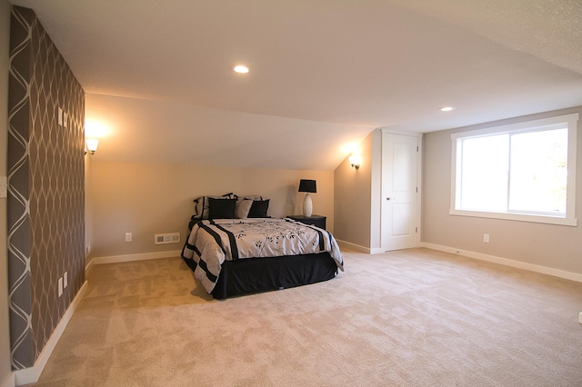 carpeted bedroom featuring lofted ceiling